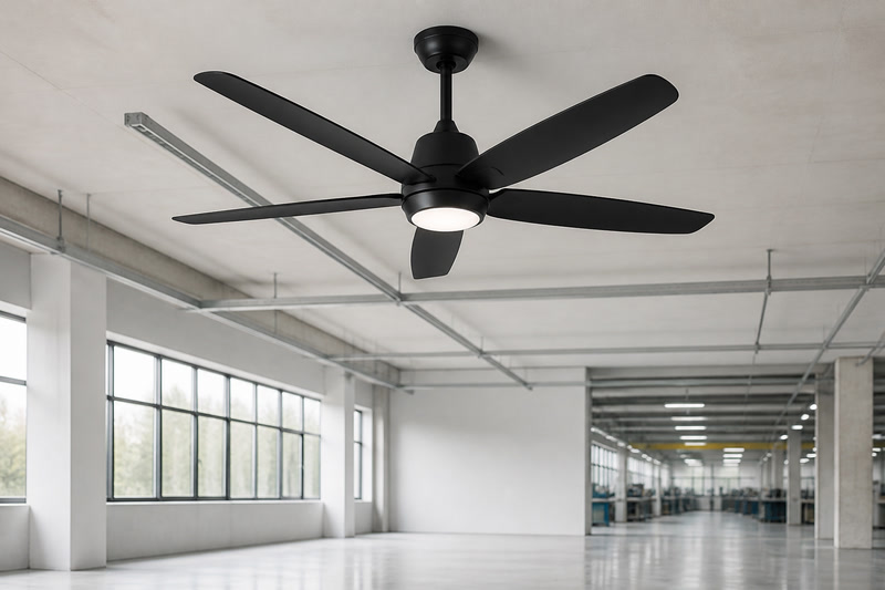 Matte-black ceiling fan displayed in a bright factory inspection space